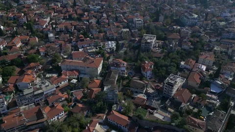 An aerial shot from a camera flying forward over an old town with red tile roofs Stock Footage 229795712