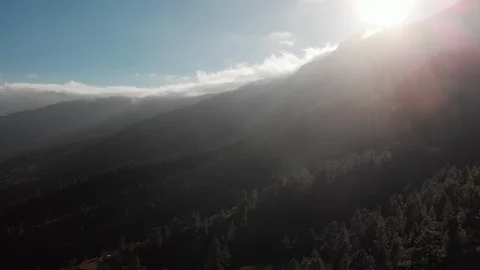 Aerial shot. Camera movement backwards. At sunset in the mountains. Against the Video stock 104590661