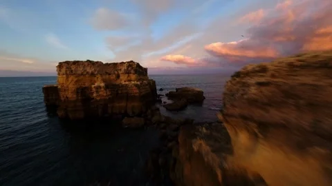Aerial shot captures dramatic coastline during golden hour Video stock 346091816