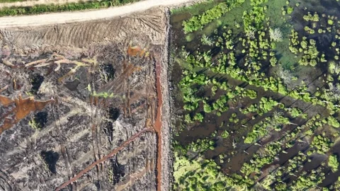 Aerial shot captures a road under construction and a completed highway Stock Footage 345522902