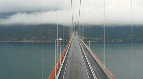 Aerial Shot Car Crossing Suspension Bridge across River in Norway. Stock Footage