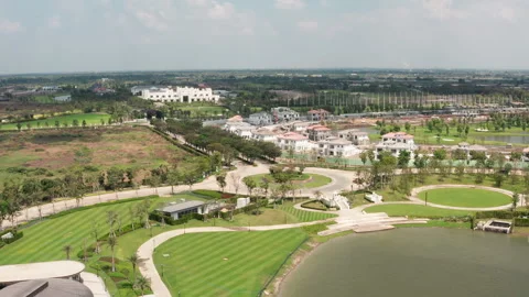 Aerial Shot of Car Driving Down Boulevard at Luxurious Gold Resort in Video stock 268308511
