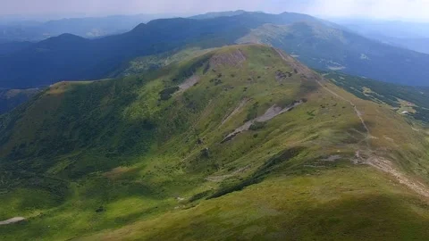 Aerial shot of the Carpathian range with a thin lane in summer Stock Footage 86320981