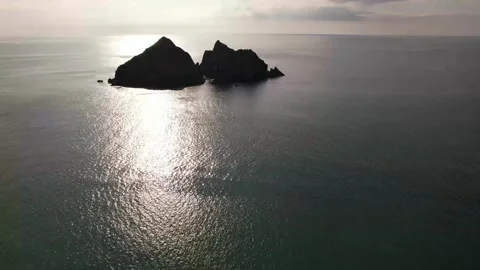 Aerial shot of Carter's Rocks in low sun, Holywell Beach in Cornwall, England Stock Footage 336510396