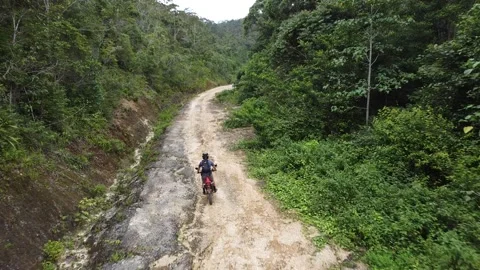 Aerial Shot Chasing Dirt-bikes Through Jungle Stock Footage 168513592