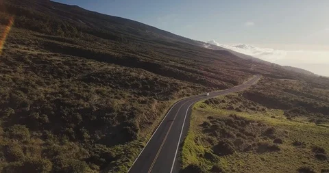 Aerial Shot of Chevy Sonic driving down mountain road in Hawaii. Stock Footage