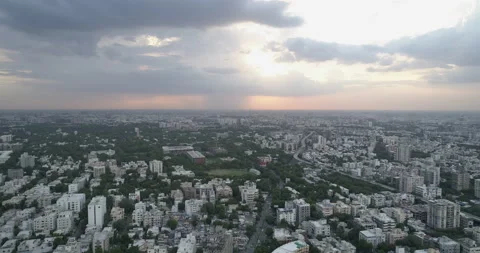 Aerial shot of a cityscape with dramatic clounds in the distance, 4K Stock Footage 157238299