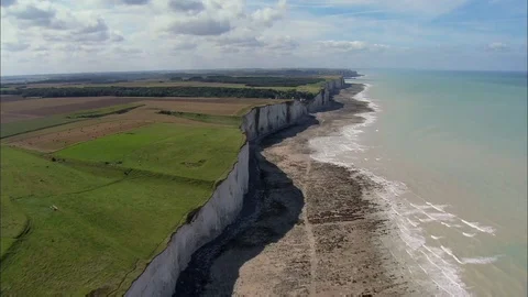 Aerial shot of cliffs, shore, fields and ocean. Stock Footage 99059104