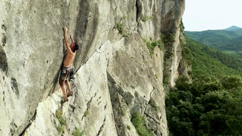 Aerial shot of a climber on a difficult climbing route. High limestone cliff Video stock 132105545