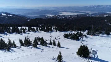 Aerial shot of a closed ski lift in the snowy mountains Stock Footage