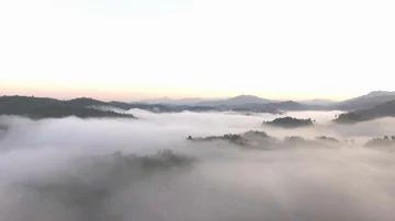Aerial shot : cloud surfing in mountain rang sunrise background Stock Footage 85586735