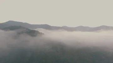 Aerial shot : cloud surfing in mountain rang sunrise background Stock Footage 85643175
