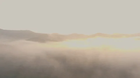 Aerial shot : cloud surfing in mountain rang sunrise background Stock Footage 85657477