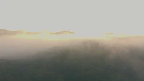 Aerial shot : cloud surfing in mountain rang sunrise background Stock Footage 85665802