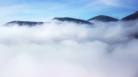 Aerial shot from the clouds. Fly over white clouds, blue sky. Stock-Footage 221789006