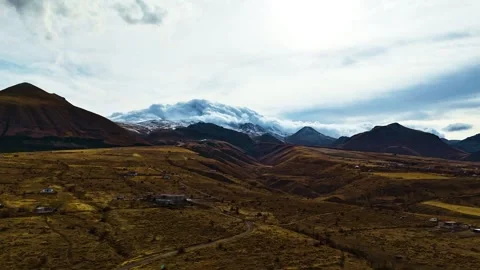 Aerial Shot of Clouds Passing Over Mountains as Winter Begins Stock Footage 293085688