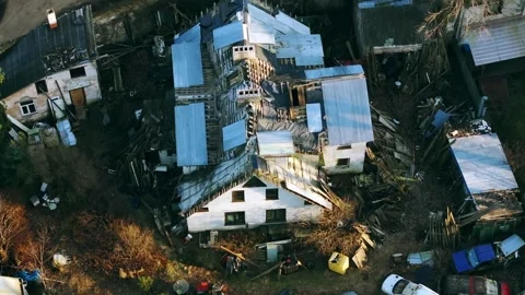 Aerial shot of cluttered yard filled with junk and ruins in central Riga, 4K 動画素材 308635818