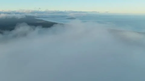 Aerial Shot Of Coast Covered By Clouds, 6K Video stock 333560410
