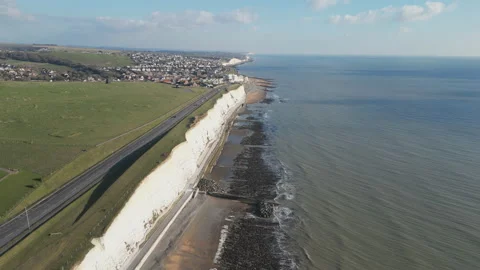 Aerial shot of a coastal town with white cliffs in England. Stock Footage 231063053