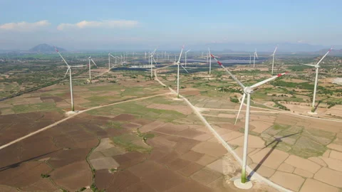 Aerial shot of a complex of wind turbines standing on a big farming field. Green Stock Footage 138288369