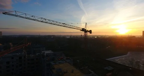 Aerial shot of a construction crane at sunset. City silhouettes in the dusk - 3 스톡 동영상 87569715