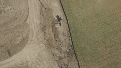 Aerial shot construction site camera facing down rotating in a sunny day Stock Footage 61111386