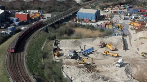 Aerial shot of construction, train passes by 스톡 동영상 47783898