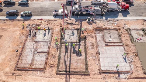 Aerial shot of construction workers building foundation of new house in Vegas Stock Footage 201159415