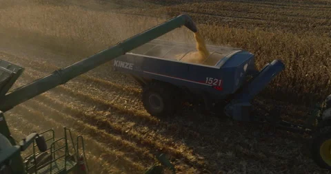 Aerial Shot of Corn Emptying Into Grain Cart During the Harvest Stock Footage 219760632