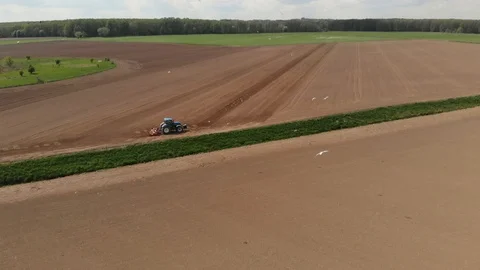 Aerial shot of crops with tractor Stock Footage 89900698