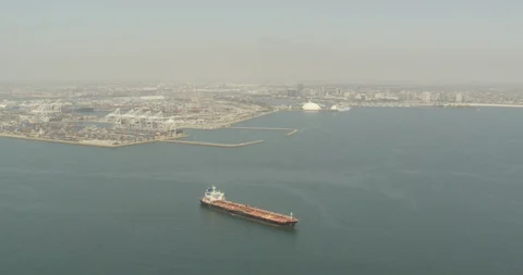 Aerial shot, day, empty cargo ship floats off long beach harbor, drone 스톡 동영상 115216930