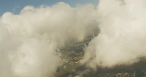 Aerial shot, day, focus on clouds with clearing in the center showing highway Stock-Footage 115284886