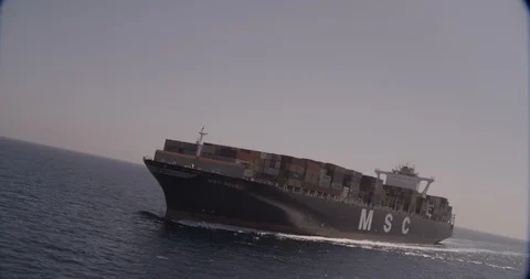 Aerial shot, day, front rotating view of cargo ship at sea, drone Stock Footage 115435050
