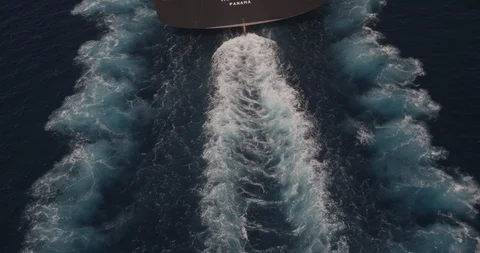 Aerial shot, day, top down view of wake being cut into sea by ship, drone Stock Footage 115435122