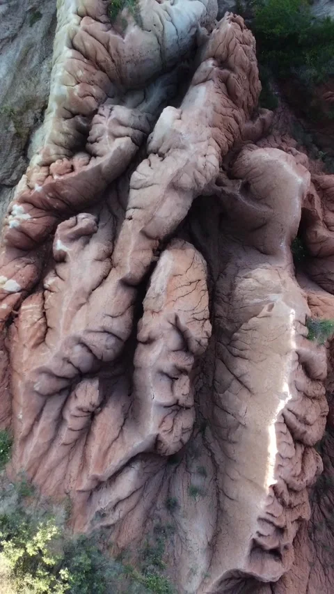 Aerial shot of deeply wrinkled mud ridges and layered clay in Kazakhstan Stock Footage 338129337
