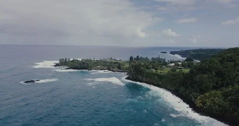 Aerial Shot of Distant ocean waves hitting peninsula in Hawaii Stock Footage 92041981