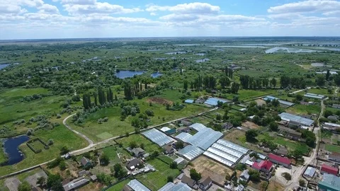Aerial shot of the Dnipro basin with country roads, houses, greenary in summer Stock Footage