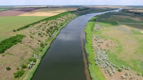Aerial shot of the Dnipro, its hilly banks with trees rusty grass on a sunny day Stock Footage 86851253