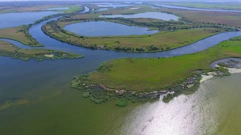 Aerial shot of the Dnipro riverbed with round islets and inflows at sunset Video stock 87007529