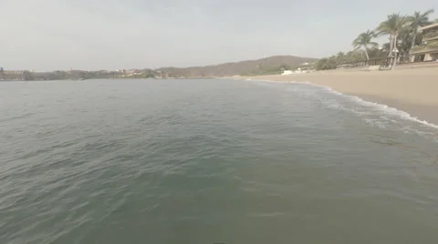 Aerial shot down beach of waves Vidéo 50039980