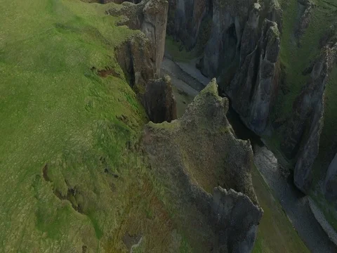 Aerial shot of dramatic cliffs with river in Iceland. Video stock 72322962