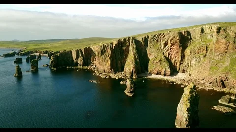 Aerial shot off the dramatic coast line of Shetland, Scotland, Stock Footage 97804351