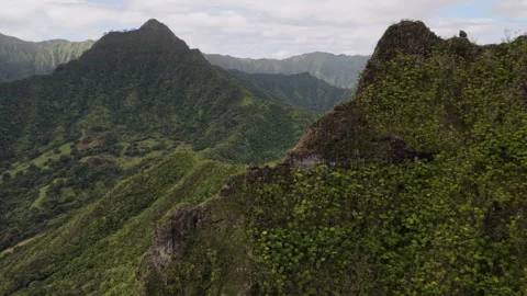 Aerial shot of dramatic mountain peaks covered in lush tropical vegetation Stock Footage 332609193