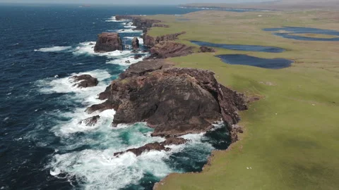 Aerial shot of a dramatic sea cliffs on the western coast of Shetland, in Stock Footage 311507478