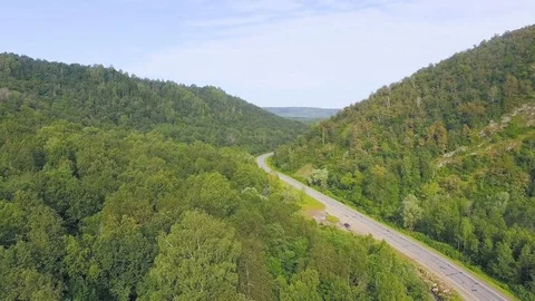 AERIAL: Shot from drone - empty asphalt road, among wild forest in the mountains Stock-Footage 78034562