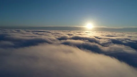 Aerial shot. Drone flying down through the clouds during sunrise. Vídeos de archivo 142073112