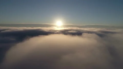 Aerial shot. Drone flying down through the clouds during sunrise. Vídeos de archivo 142073202