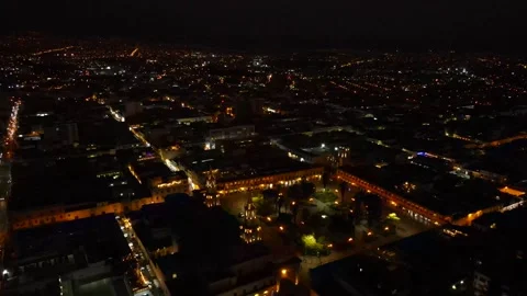 Aerial shot drone orbits to right around Plaza de Armas in Arequipa at night Stock Footage 243698175