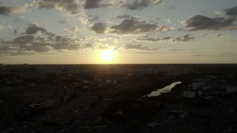 Aerial Shot drone view Flying directly at sunset over the lake and the city Stock Footage 111908732