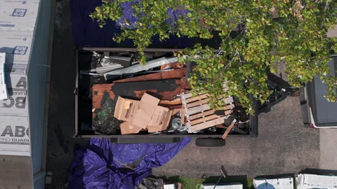 Aerial shot of Dumpster full of garbage from an home. Naperville IL USA 2 sept Stock Footage 296086453